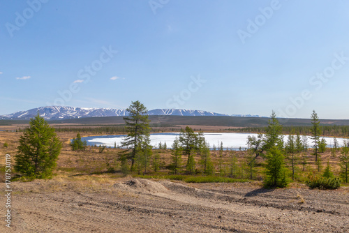 Russia, Magadan Region. Nature of Siberia and the Russian Far East. A small ice-covered lake in the tundra in the area of Lake Malyk.