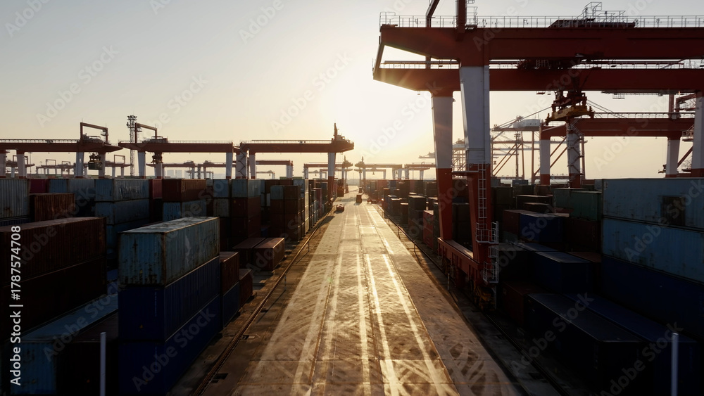 Obraz premium Unloading large cargo containers seaport. Loading freight sea port. Top aerial drone view. Lot big boxes rows, ship delivery ocean harbor. Industrial Shipping day. Goods export import. Marine dock.