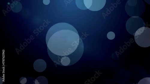 Dark blue abyss background with large abstract bokeh light particles slowly moving up