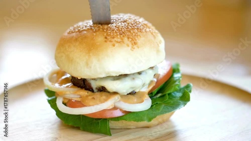 Isolated hamburger rotates on table wood background, and french fries rotating