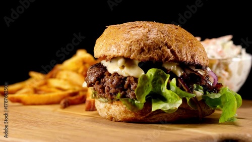 close-up view Cool beautiful fresh juicy cooked burger rotate on turntable,