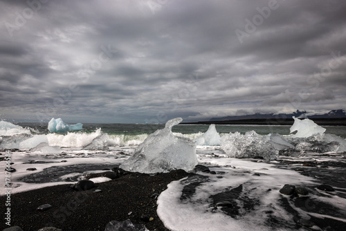 Ice blocks on a black sand beach named Diamond Beach  in Iceland