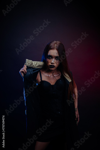 Elegant Asian woman with serious expression and spotlight illumination, creating a movie-like portrait.