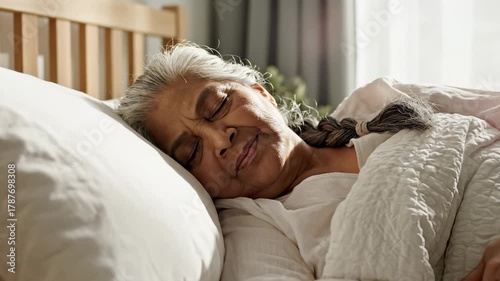 Senior Woman Sleeping Peacefully in Bed With Natural Light