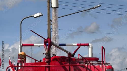 Fire trucks are filling up with water.