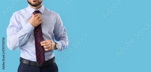 Young businessman fixing hi...