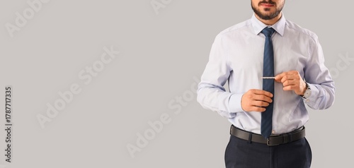 Young businessman fixing ne...