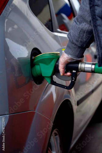 The process of refueling a car with gasoline fuel