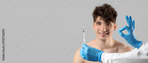 Young man receiving injecti...