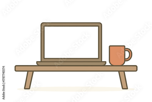 Laptop computer and coffee mug on small wooden table