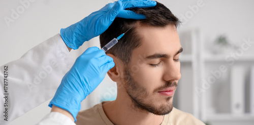Young man receiving injecti...
