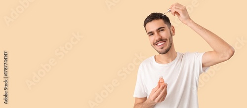 Young man using serum for h...