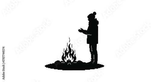 Silhouette of a person in warm clothing warming hands by a campfire in the dark.