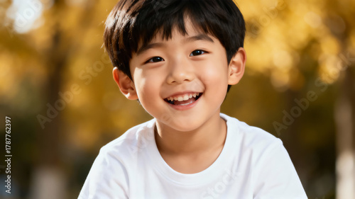 Portrait of a joyful asian 5-year-old boy in a T-shirt on a white background