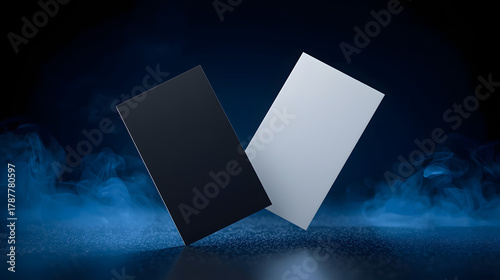 Contrast of Ideals: A pair of sleek cards, one black, one white, hover against a backdrop of ethereal blue vapor, symbolizing duality and contrasting concepts.