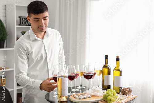 Young sommelier with glasse...