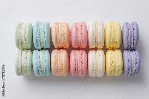 Top view of colorful macarons on white background. Multicolour macaroon sweet dessert French cuisine style for coffee break