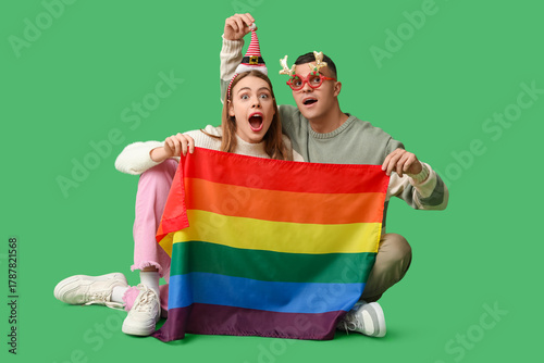 Young couple with LGBT flag...
