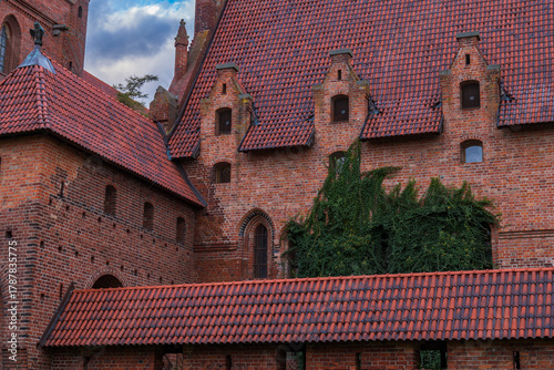Malbork Castle red brick Gothic roofs and stepped dormers at dusk