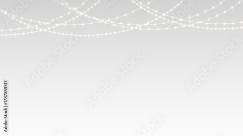 Garland festive christmas holiday lights and ribbon decoration hanging over party banner stage.
