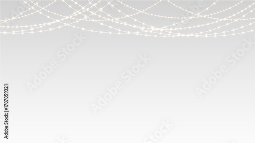 Garland decorated with glowing lights and festive ribbons across christmas holiday stage banner.
