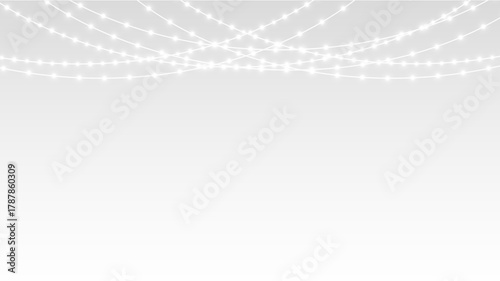 Garland hanging Christmas festive bulbs and LED lights with ribbon decoration for holiday.
