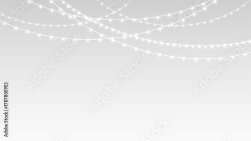 Garland with glowing fairy lights and festive ribbons decorating Christmas holiday stage.
