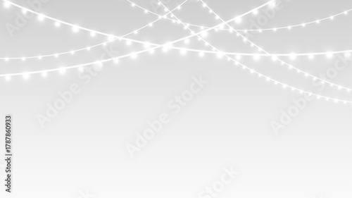 Garland decorated with festive Christmas lights and glowing ribbons for holiday event celebration.
