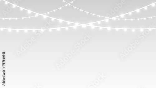 Garland decorated with fairy lights and glowing bulbs on festive Christmas holiday background.
