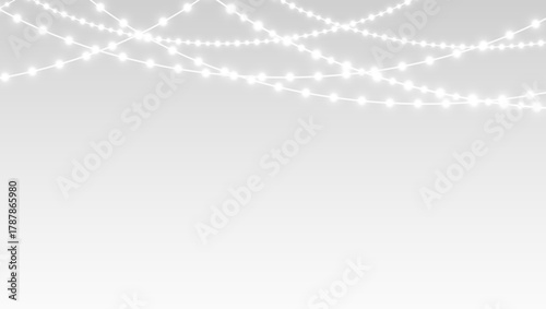 Garland glowing lights and festive christmas ribbons hanging over holiday party stage.
