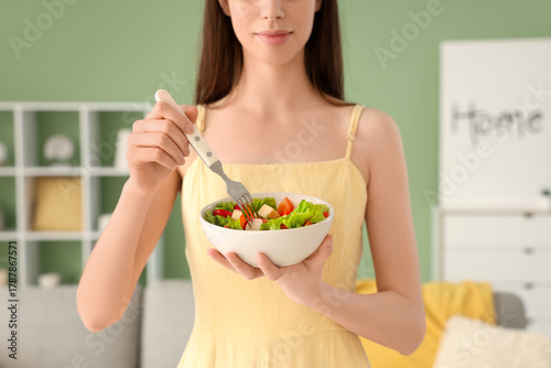 Young woman with bowl of ve...