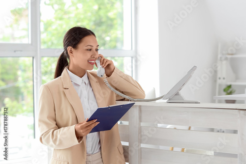 Young female receptionist h...