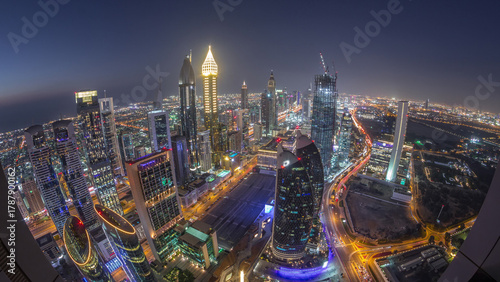 Skyline of the buildings of Sheikh Zayed Road and DIFC aerial day to night ti...