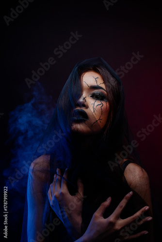Dark art portrait of Asian woman with veil