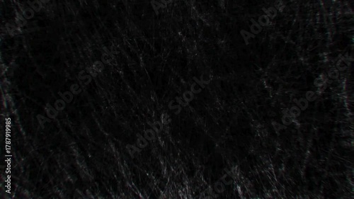 Dark macro texture of rain drops forming a wet pattern on a black window surface backdrop