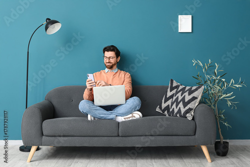 Handsome man with laptop us...