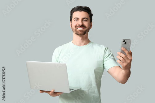 Young man with modern mobil...
