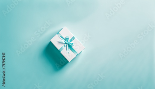 white gift box with blue ri...