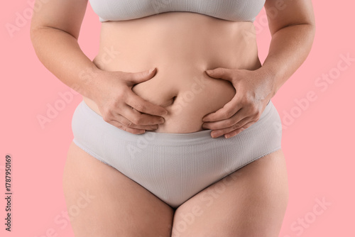 Wallpaper Mural Overweight woman in underwear on pink background, closeup Torontodigital.ca
