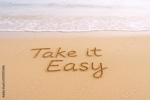 Take it easy message on sandy beach with wave approaching, ideal for vacation or relaxation concept
