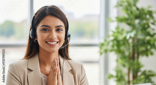 Indian call center professional in a headset offers a namaste greeting with joined hands Free Download Indian call center professional in a headset offers a namaste greeting with joined hands - GFXLoad