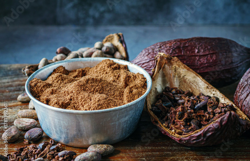Close-up of Natural cocoa powder with brown cocoa beans and dry cacao nibs