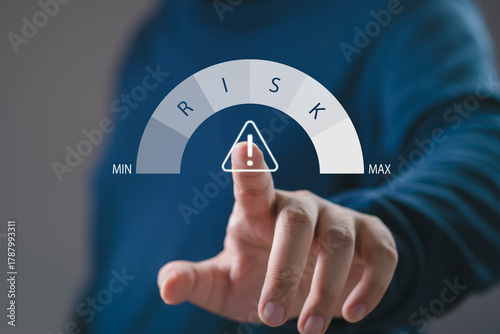 A person touching a virtual risk level gauge with warning icon, symbolizing business risk management, financial analysis, investment strategy, and decision-making in modern technology concepts.