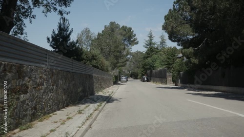 Matadepera road street asphalt gimbal traveling pine trees day