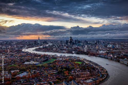 Panoramic view of the urban skyline of London, England, stretching from south to north during a moody autumn sunset with clouds
