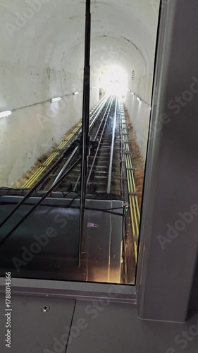 Exploring mountain descent along narrow railway through trees