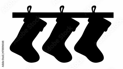 Three classic black Christmas stockings hang ready for holiday treats, evoking festive joy and anticipation for Santa's gifts