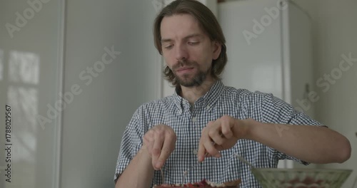 Man is Eating Breakfast in Kitchen. 4K 10-bit