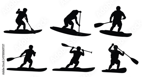 Silhouettes of people paddleboarding enjoying a watersport activity in dark shades
