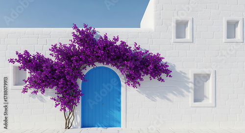 Blue door with purple flowers on a white brick building under a bright blue sky on a sunny day
